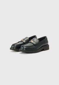 Black leather loafers with a round toe, decorative stitching, and a gold-tone accent on the strap. Low block heel. Smooth texture.