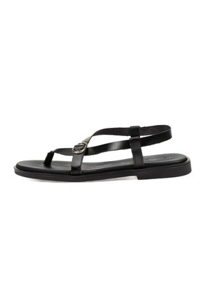 Sandaleta plana negra con tiras finas y hebilla ajustable, diseñada para un uso casual con un estilo minimalista.