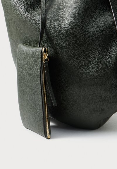 Green textured leather bag with a detachable pouch featuring a gold zipper. The bag has a rounded shape and soft finish.