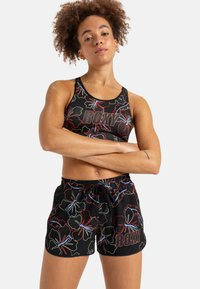 Black athletic outfit featuring a floral pattern in red and blue. The sports bra has a logo, and the shorts have an elastic waistband with a drawstring.