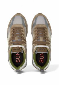 Para beżowo-szarych sneakersów na sznurówki z zielonym wnętrzem, widzianych z góry, z widocznym logo "SUN68" na języku i wkładkach.