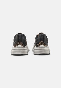 Sneaker nere e con stampa leopardata con dettagli in rete, suole bianche testurizzate e marchio sul tallone. Forma arrotondata, design casual.