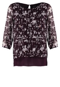 Lila Bluse mit floralem Muster, aus transparenter Stoff, mit Dreiviertelärmeln, Rundhalsausschnitt und Knopf im Rücken, leicht, mit mehrlagigem Saum und einfarbigem Unterteil.