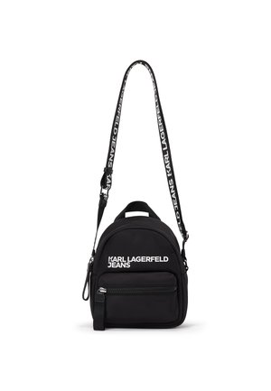 Black mini backpack with front zipper pocket and adjustable shoulder strap featuring "Karl Lagerfeld Jeans" branding in white.