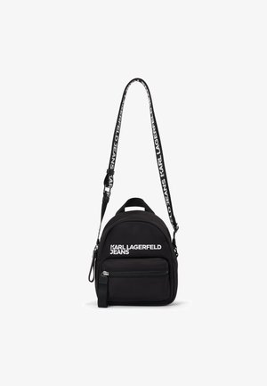 Zaino mini nero con tasca anteriore con zip e tracolla regolabile, caratterizzato dal marchio "Karl Lagerfeld Jeans" in bianco.