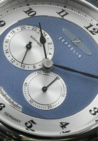 Men's automatic Zeppelin watch features a textured blue dial, silver sub-dials, black hands, and a stainless steel case.