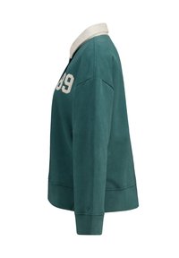 Felpa verde con colletto a polo, caratterizzata da un colletto chiaro a contrasto e il numero "89" in avorio sulla parte anteriore. Vestibilità rilassata.