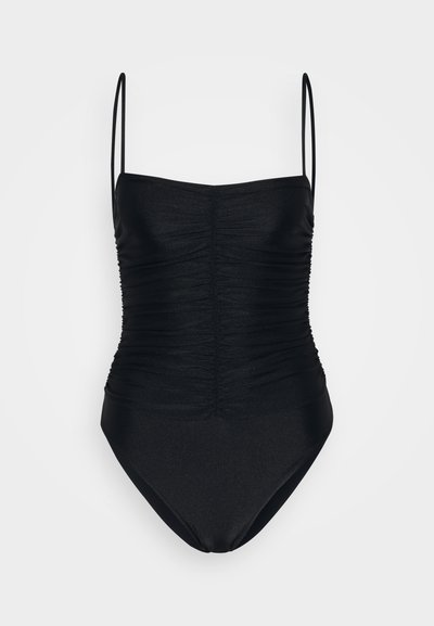 Melnā viengabala peldkostīma bikini ar regulējamiem spaghetti siksniņām, savelkumu priekšpusē un gludu, stiepjamu audumu. Augsta kāju izgriezuma atvere.