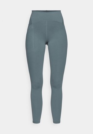 Høytlivede, hel-lengde leggings laget av glatt, elastisk stoff i en dempet blågrå farge; har en subtil sømdesign og sidelomme.