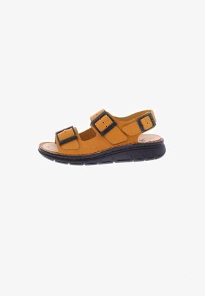 Leren sandalen in bruin met twee zwarte verstelbare gespen, kurken voetbed en een gevoerde zwarte rubberen zool, met een ronde vorm.