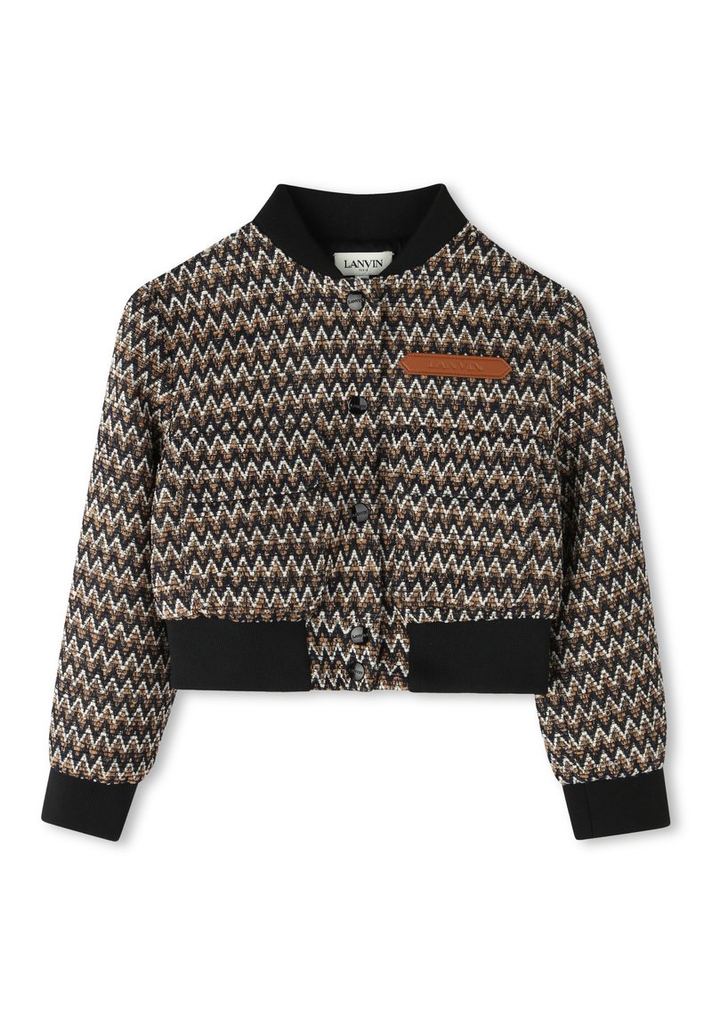 Cropped jacket with a zigzag pattern in brown, black, and cream. Features a black ribbed collar and cuffs, with a small leather logo patch.