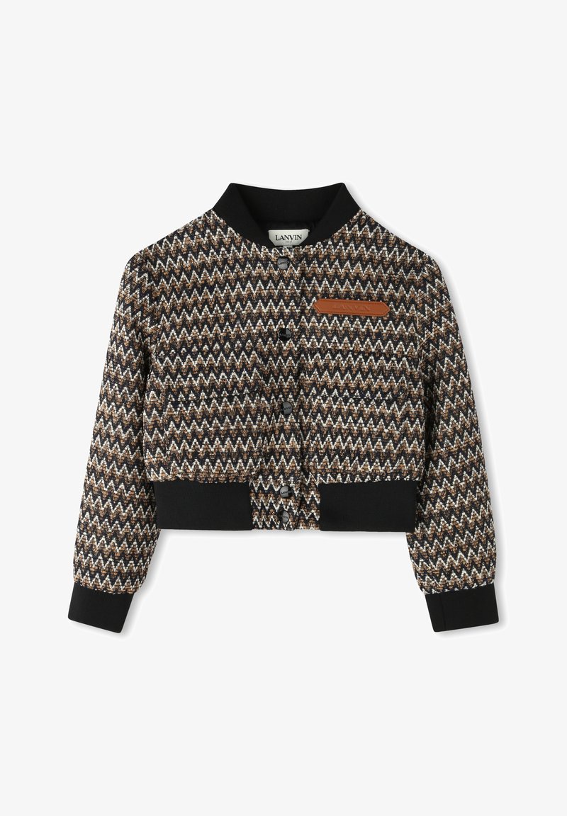 Cropped jacket with a zigzag pattern in brown, black, and cream. Features a black ribbed collar and cuffs, with a small leather logo patch.