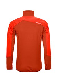 Red and orange athletic jacket, with a high collar, long sleeves, textured body, and contrasting shoulder panels. Brand logo on back.