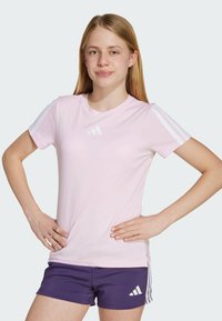 Light pink athletic t-shirt with short sleeves, featuring three white stripe accents on shoulders and a small white logo on the chest.