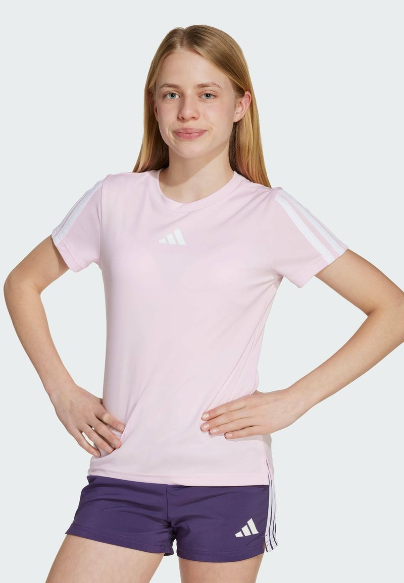 Light pink athletic t-shirt with short sleeves, featuring three white stripe accents on shoulders and a small white logo on the chest.
