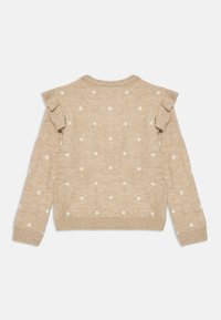 Beige genser med hvite prikker, ribbede mansjetter og rynket design på skuldrene. Myk tekstur med rund hals.