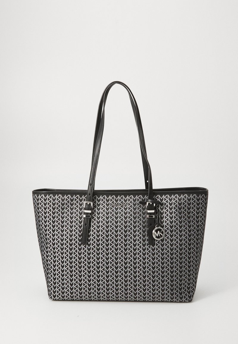 Black and white patterned tote bag with leather straps and silver hardware. Features a geometric design and a logo charm.