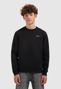 Zwarte sweatshirt gemaakt van zachte stof, met een ronde hals, ribgebreide manchet en een klein wit logo op de linkerborst. Casual pasvorm.