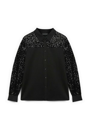 Blusa nera con colletto e bottoni frontali, con tessuto nero ricoperto di paillettes sulle maniche superiori e sulle spalle. Materiale morbido, vestibilità rilassata.