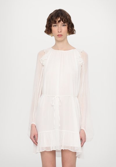 White, lightweight dress featuring long sleeves, ruffled accents, a tie waist, and a layered ruffle hem. Sheer texture with a flowing design.
