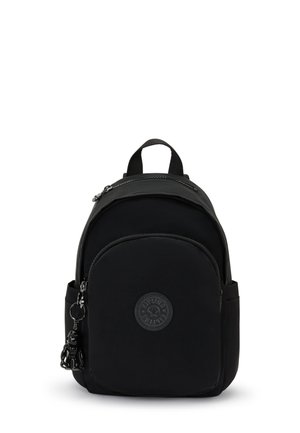 Black nylon backpack with a rounded shape, front zip pocket, rubber logo patch, and small decorative keychain. Adjustable straps.
