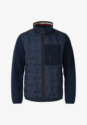 Veste matelassée bleu marine avec fermeture éclair rouge intégrale, col montant, poche poitrine zippée et poignets élastiques sur les manches longues.