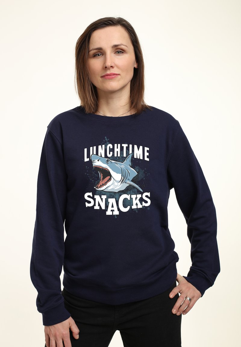 Marineblaues Sweatshirt mit einem Grafik eines Hais und dem Text "LUNCHTIME SNACKS" in Weiß. Hat lange Ärmel und einen runden Ausschnitt.
