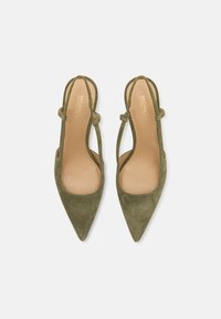 Green suede slingback pumps with a pointed toe, open sides, and a slender ankle strap. The insole features gold branding detail.