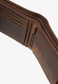 Brown leather wallet with multiple card slots, a zippered compartment, and smooth texture; features reinforced stitching and subtle branding.