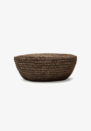Round, low-profile dark brown woven basket with tightly braided pattern, photographed against white background.