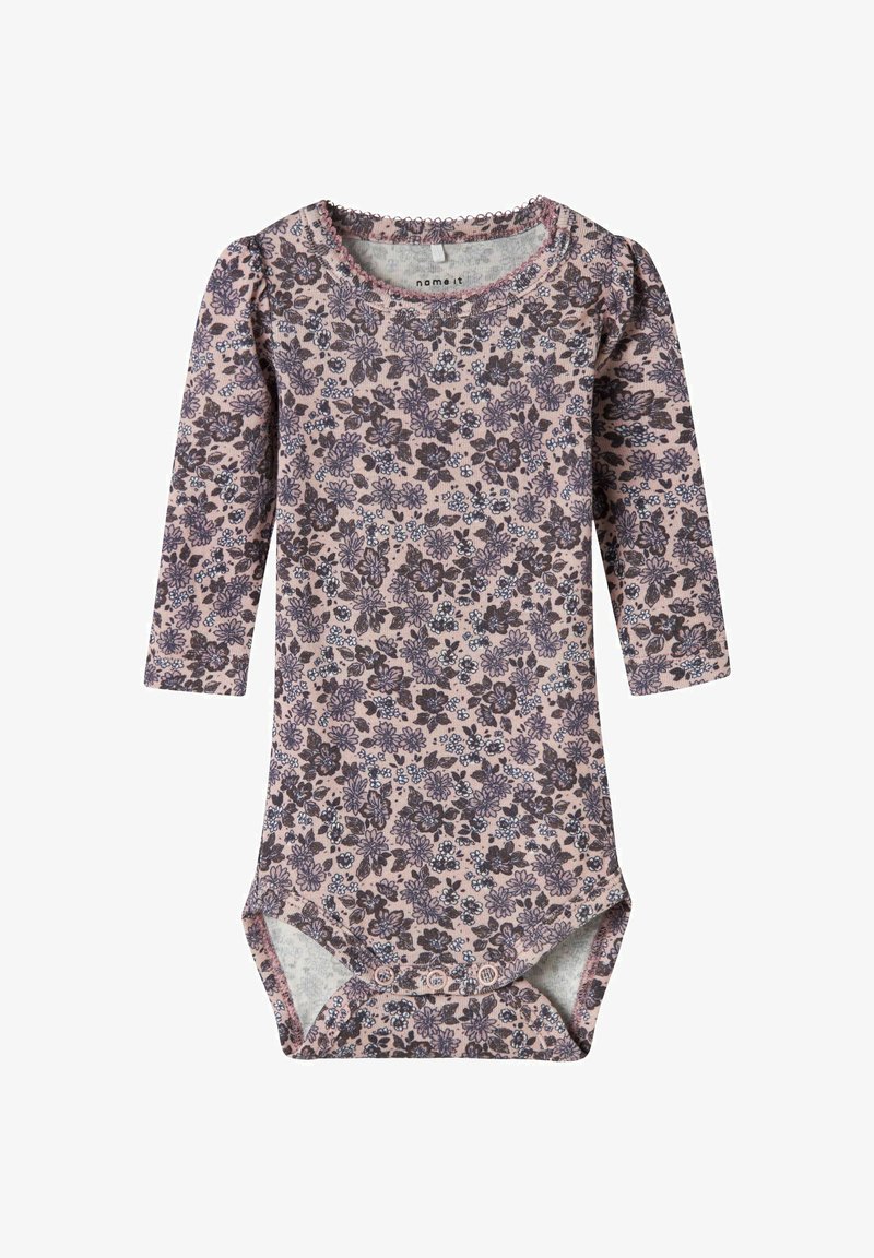 Bloemige longsleeve bodysuit in zachtroze stof, met donkere paarse en blauwe bloemenpatronen, een geplooide halslijn en drukknoopsluiting aan de onderkant.