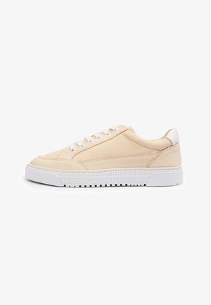 Sneaker in suede beige con lacci bianchi e suola in gomma. Design minimalista con texture liscia e dettagli di cucitura discreti.