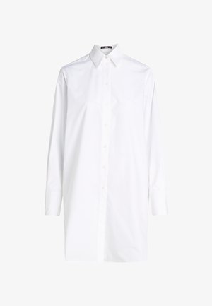 Bela dolgorokav shirt iz bombaža, z klasikim ovratnikom, gumbnim zapiranjem in subtilnimi šivi na sprednji strani.