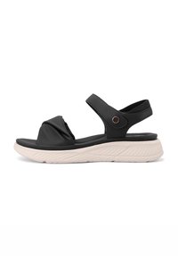 Sandalo nero con design annodato, cinturino regolabile e suola leggera con texture. Presenta una tomaia imbottita e una suola di contrasto chiara.