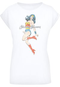 White t-shirt featuring a vintage Wonder Woman graphic. The design includes her iconic costume colors: red, blue, and gold, with a soft texture.