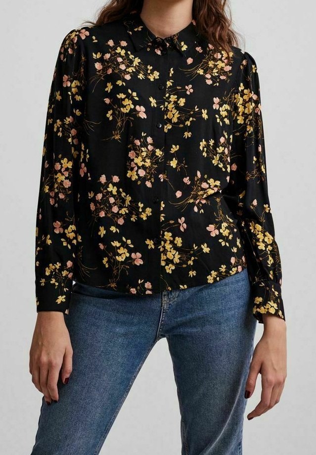 Black floral blouse with long sleeves, featuring pink and yellow flower patterns, button-up front, and classic collar. Smooth fabric texture.
