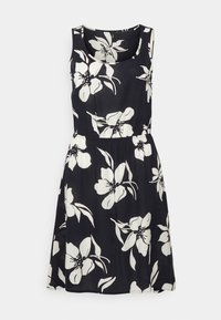 Schwarzes ärmelloses Kleid mit großen weißen Blumenmustern, tailliertem Schnitt und ausgestellt Rock. Hergestellt aus leichtem Stoff.