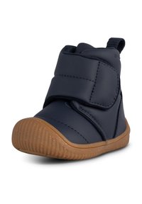 Navy blue waterproof boot with Velcro closure, rubber sole, and textured brown outsole. Features a soft, cushioned interior for comfort.