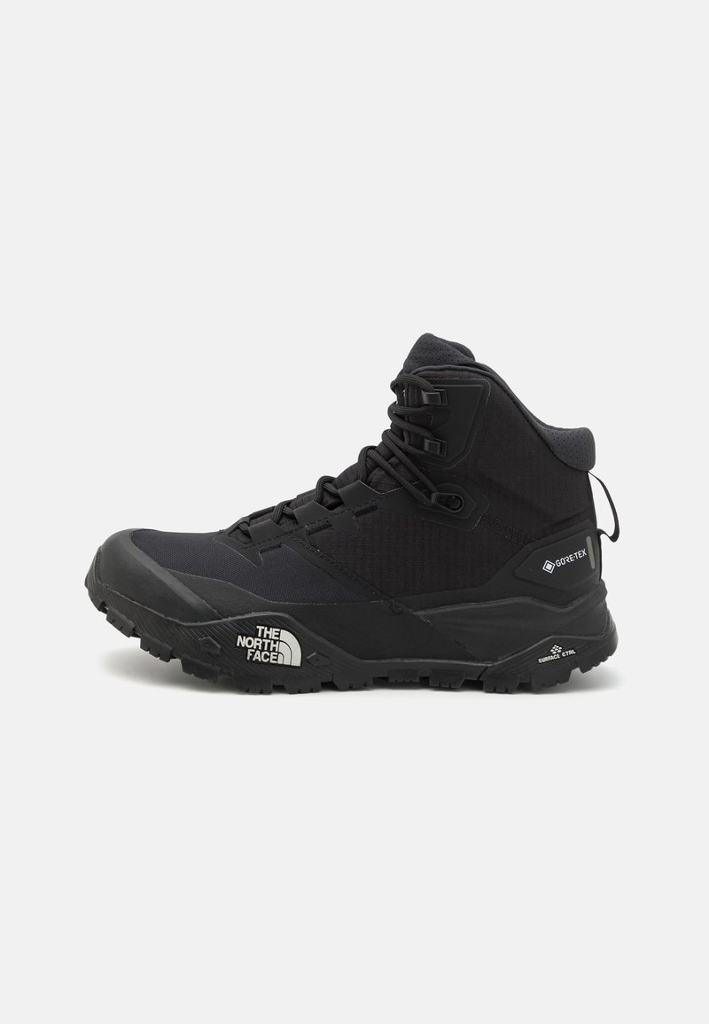 Black hiking boot with a high-top design, featuring a textured fabric upper, reinforced toe cap, and rubber sole with aggressive tread.