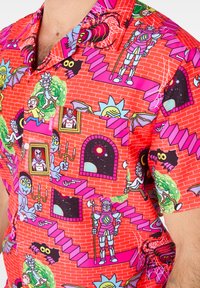 Short-sleeve shirt with a bright red fabric featuring colorful cartoon patterns, including characters, staircases, and brick wall designs.