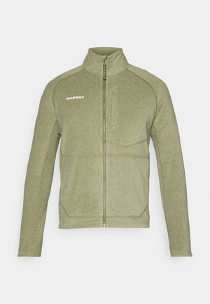 Veste en polaire zippée de couleur vert olive avec un col haut, un tissu texturé et des coutures contrastées. Nom de la marque "Mammut" imprimé sur la poitrine.