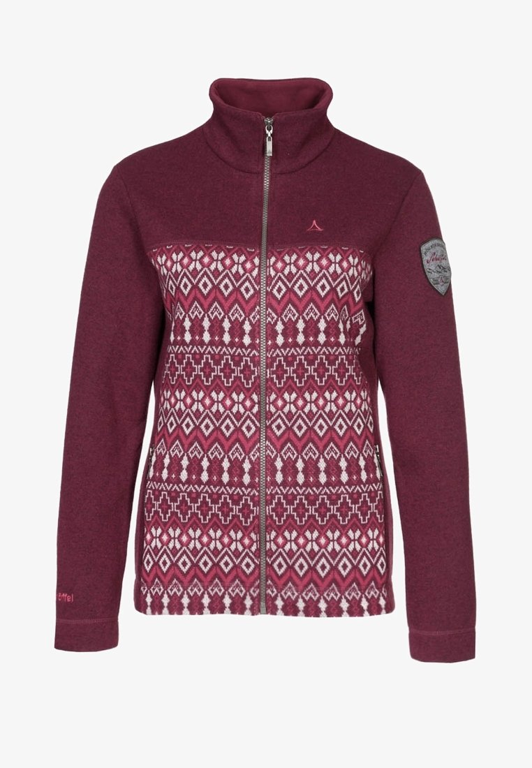 Veste polaire bordeaux avec fermeture éclair intégrale, col haut, motifs géométriques blancs et roses à l'avant, et écusson en forme de bouclier sur la manche gauche.