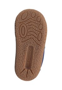 Suela de zapato de goma marrón con superficie texturizada que presenta formas ovaladas y patrones de ondas. Logo "MUNICH" en relieve en el centro.