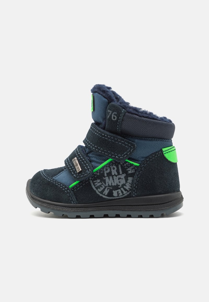 Bottine pour tout-petit bleu marine avec accents verts, double fermeture Velcro, semelle texturée et doublure en polaire douce.