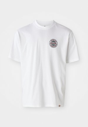 White cotton t-shirt with a round logo on the chest. Crew neckline, short sleeves, relaxed fit, featuring red and black accents.