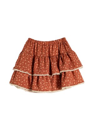 Kerroksellinen hame poltettu oranssissa kankaassa, jossa on valkoista kukkakuosia ja pitsireunus helman ympärillä. Elastinen vyötäröauko mukavuutta varten.