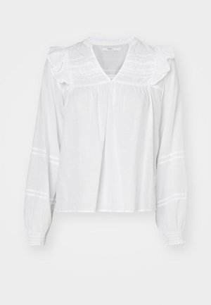 Blouse blanche à manches longues avec des détails de volants sur les épaules, un col en V et des poignets froncés. Présente des rayures horizontales le long des manches.