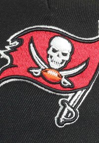 Red and black embroidered Buccaneers flag featuring a skull and crossbones design with a football in the center.