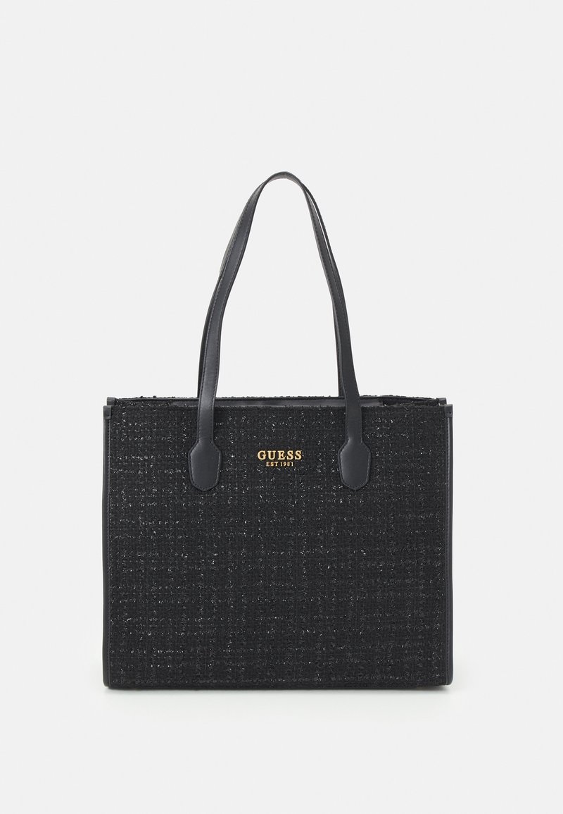 Sac tote Guess noir texturé avec deux longues anses et logo de la marque doré "GUESS EST 1981" au centre avant.