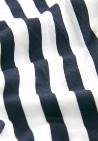 Cotton fabric featuring alternating navy blue and white stripes, with a slightly crumpled texture, displaying smooth, uniform lines.